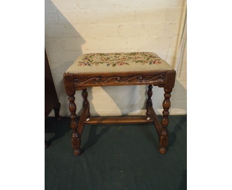 An Edwardian Carved Oak Rectangular Topped Stool with Tapestry Upholstery.