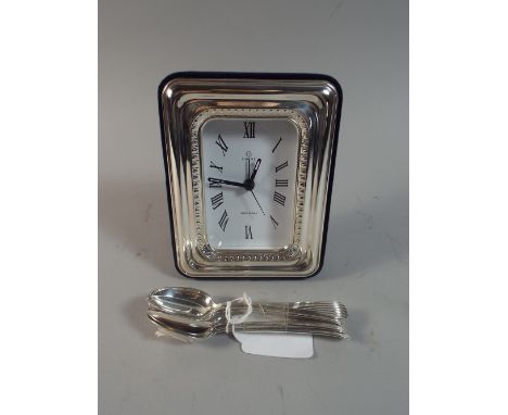 A Collection of Six Silver Tea Spoons and A Silver Mantle Clock. 