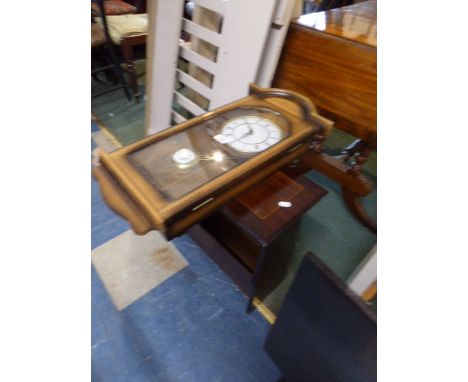 A Modern Wall Clock By the London Clock Company Together with a Mahogany Magazine table 