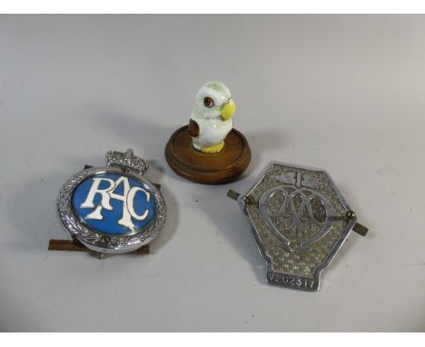 A Ceramic Mascot in the Form of a Parrot Together with a Vintage AA Car Badge and a RAC Badge