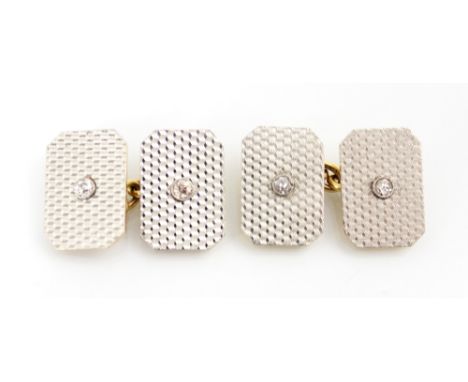 A pair of early 20th century diamond set cufflinks, the white metal fronted rectangular cufflinks with engine turner detail a