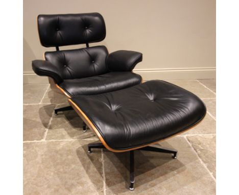 A Charles and Ray Eames style rosewood reclining chair and ottoman, late 20th century, having black leather button upholstery