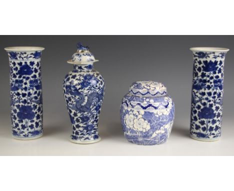 A pair of Chinese porcelain blue and white rouleau vases, 19th century, each of cylindrical form and decorated with two scrol