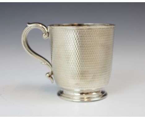 A Victorian silver mug, R and S Garrard &amp; Co, London 1867, the scroll handle above an engine turned body with gilt interi