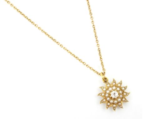An early 20th century diamond and split pearl pendant, designed as star burst with central old cut diamond, upon an associate