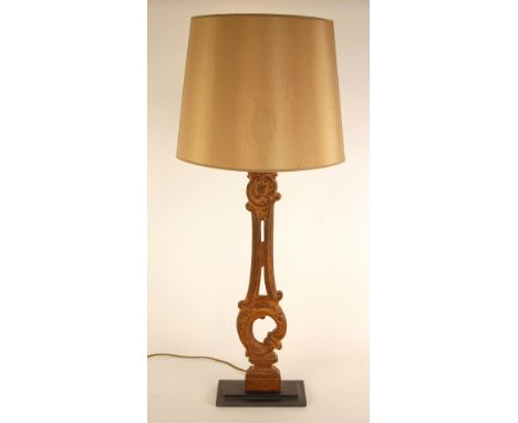 A table lamp of large proportions, modelled from a 19th century cast iron staircase baluster set to a later stepped metal bas