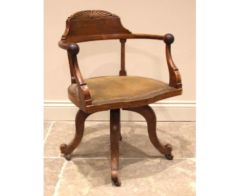 A walnut revolving office/desk chair, by Maple &amp; Co, late 19th/early 20th century, with a demi lune bat wing crest extend