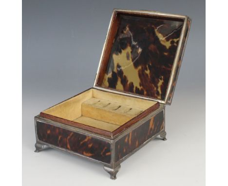 A George V silver mounted tortoiseshell jewellery casket, of square form raised on four bracket feet, velour lined interior w