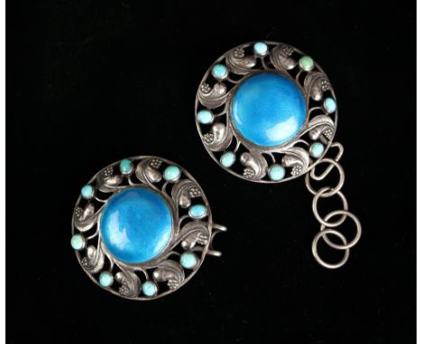 A pair of early 20th century enamel cloak clasps, possibly by Charles Robert Ashbee, the circular blue enamel discs within a 