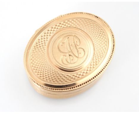 A 20th century gold coloured vinaigrette, the oval engine turned hinged cover with initial monogram to centre, opening to rev