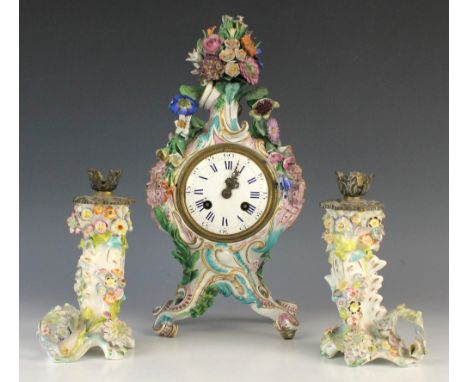 A pair of Staffordshire porcelain brass mounted candlesticks, each florally encrusted with gilt highlights throughout, 19.5cm