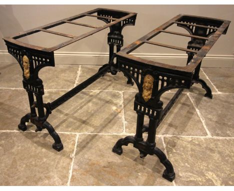 A pair of Victorian painted cast iron pub tables, each raised upon twin trestle type supports, centred with a cast female mas
