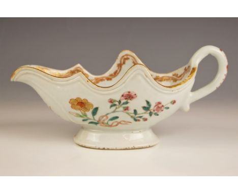 A Chinese porcelain sauceboat, 18th century, decorated in the famille rose palette, with petal shaped gilt highlighted rim, 9