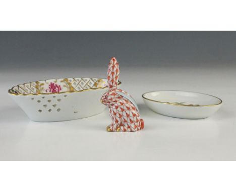A Herend porcelain model of a hare, 20th century, decorated in the Vieux Herend red fishnet design with gilt highlights, prin
