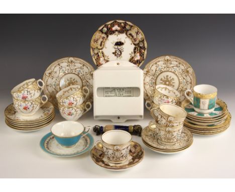 A selection of tea wares, 19th century and later, in various patterns, some with painted fraction marks, with a ceramic toile