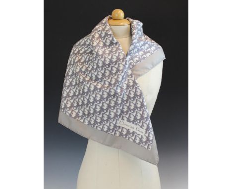 A Christian Dior silk scarf, in grey monogram within a grey border, with rolled hem, 77cm x 77cm, unboxed 