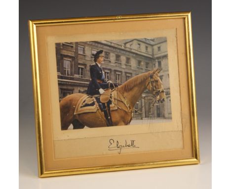 QUEEN ELIZABETH II INTEREST: A printed photograph of Princess Elizabeth mounted side saddle on a horse, set above her signatu