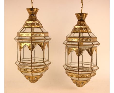 A pair of Moroccan style glass ceiling lanterns, 21st century, of typical form, stamped maker's mark, 51cm tall (excluding fi