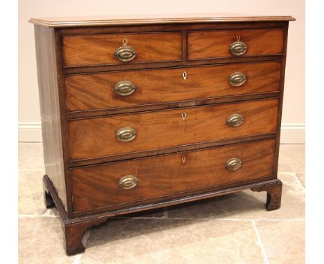 A George III mahogany chest of drawers, the moulded top over an arrangement of two short and three long graduated and cock-be