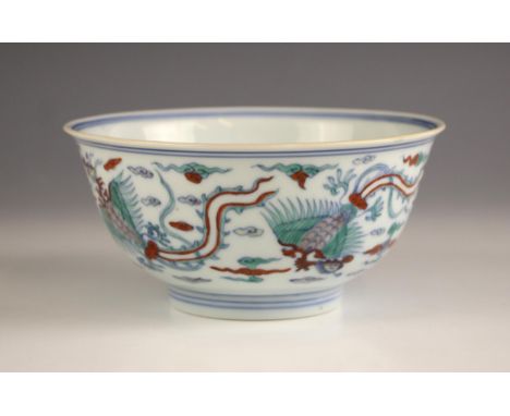 A Chinese porcelain Doucai bowl, Kangxi period (1661-1722), the circular bowl externally decorated with four phoenixes in fli