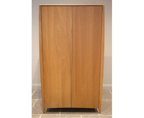 An Ercol Savona light oak two door wardrobe, late 20th/early 21st century, opening to an internal mirror, single shelf over a
