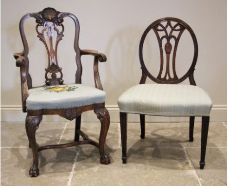 A George II style walnut elbow chair, late 19th/early 20th century, the carved shell crest uniting a pair of eagle masks on o