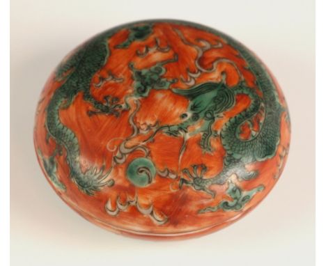 A Chinese porcelain seal box, 19th century, the circualr shaped box and cover decroated with a five-clawed green and a flamin