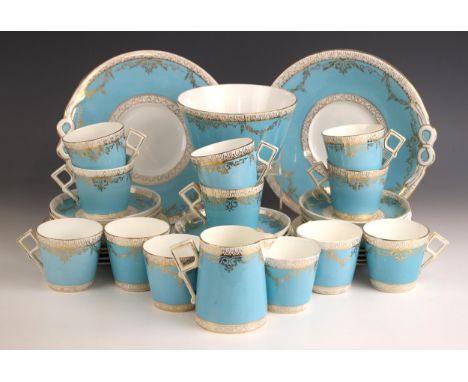 A Staffordshire part tea service, early 20th century, each piece with geometric handle and tapering blue body, gilt highlight