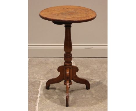 A Victorian golden oak wine/lamp table, the figured circular top upon a slender baluster pedestal and three down swept suppor