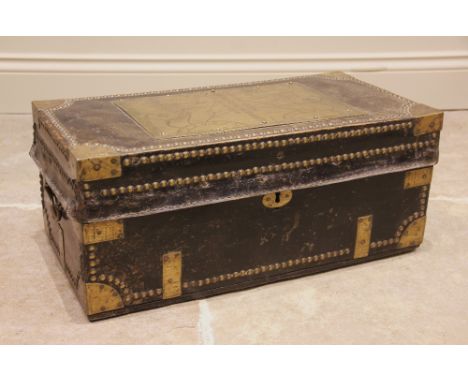 An 18th century camphorwood leather bound and brass studded trunk, the hinged cover applied with a brass plaque depicting two