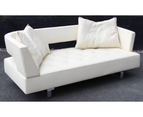 A contemporary Italian cream leather sofa by Formenti, late 20th century, with a padded and arcaded back rest, upon bushed me