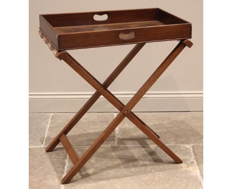 A mahogany butlers tray, 19th century, the rectangular tray with full gallery and kidney shaped hand apertures, upon an assoc