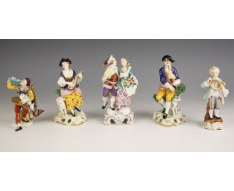 Five continental porcelain figural groups, 19th century and later, comprising: a Volkskedt harlequin playing a goat bagpipe, 