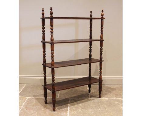 A Victorian walnut etagere/ bookcase, the four tiers upon baluster and bobbin turned supports, extending to peg feet, 120cm H