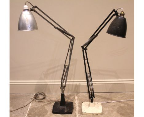 Two machinists angle poise lamps, mid 20th century, each with articulated arm upon a shaped cast base, the tallest 106cm high
