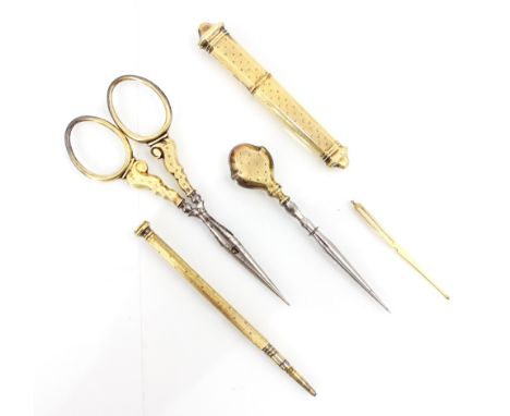 A 19th century French yellow metal travelling sewing kit, comprising needle case, pencil, scissors, and two bodkins, needle c