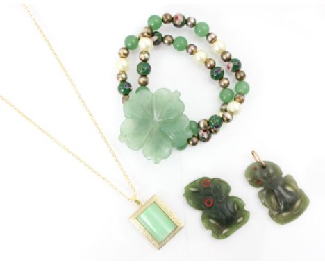 A jade coloured bracelet, the central flowerhead designed panel  with carved detail with further jade spherical beads, enamel