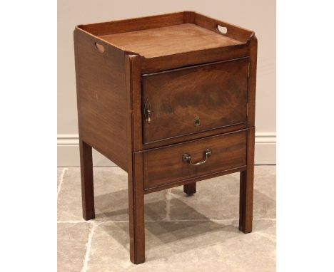 A George III mahogany tray top bedside commode cabinet, with a single cupboard door over a pull out base formed as a faux dra