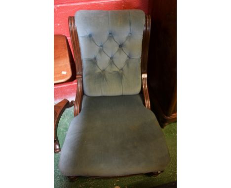 A Victorian mahogany button back nursing chair, stuffed overseat, turned forelegs, ceramic casters, circa 1860.