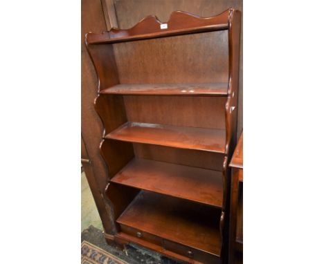 A reproduction waterfall bookcase, shaped uprights, two short drawers to base, bracket feet 151cm high x 78cm wide x 36cm dee