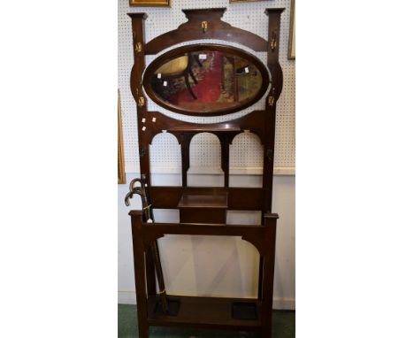 A mahogany Art Nouveau hall stand, oval pivoting mirror.