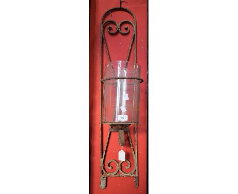 An ecclesiastical wrought iron wall mounted pricket candle lamp