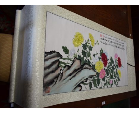 A Chinese painted scroll,chrysanthemums, calligraphy, red seal, 170cm x 60cm approximately