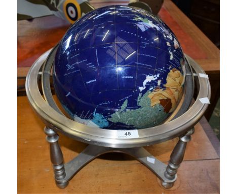 A large terrestrial globe, inlaid semi-precious stones, brushed steel stand with compass