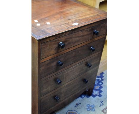 A George III mahogany commode in the form of a four drawer chest.