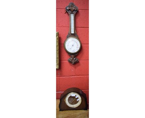 An early 20th century carved oak aneroid wheel barometer; an oak cased mantel clock (2) 