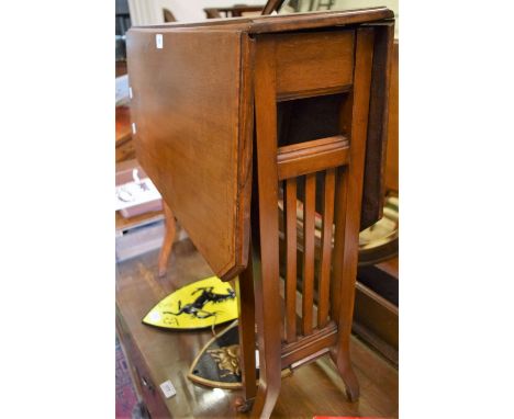 An Edwardian mahogany Sutherland table, cross banded top, canted angles, ceramic casters