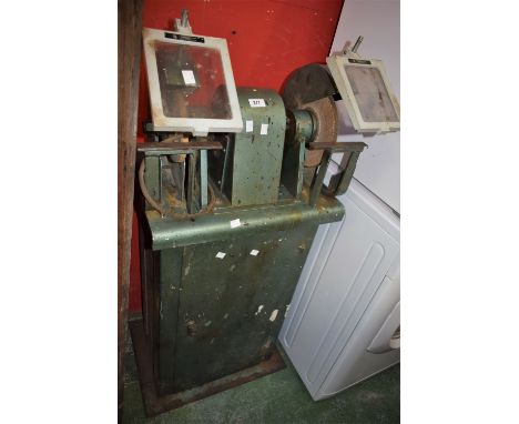 An industrial pedestal grinder.
