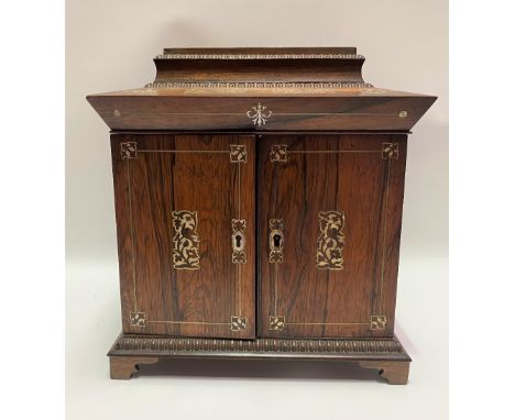 A Victorian rosewood and mother of pearl inlaid tabletop vanity cabinet, the caddy top hinged to reveal a pink shot silk fitt