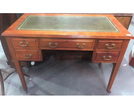 Edwardian writing table with green leather gilt tooled writing inset and moulded top over a kneehole recess and arrangement o